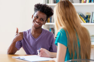 African american male student with tutor in university setting